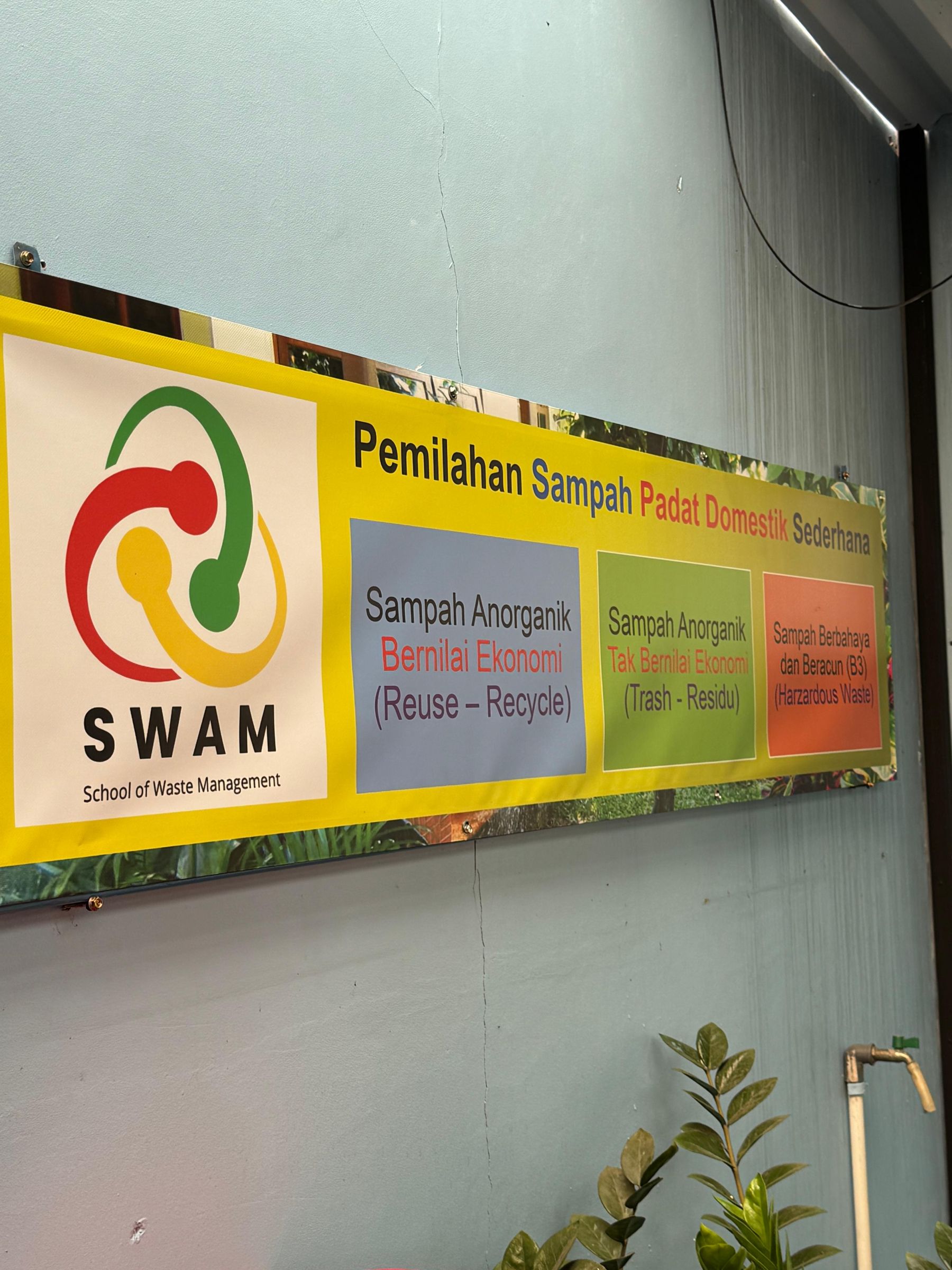 Spanduk edukasi pemilahan sampah padat domestik dari School of Waste Management (SWAM)